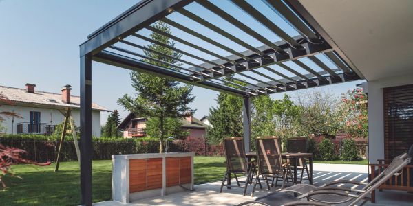 Sturdy Metal Pergola Attached to Side of House Can Support Ceiling Fan